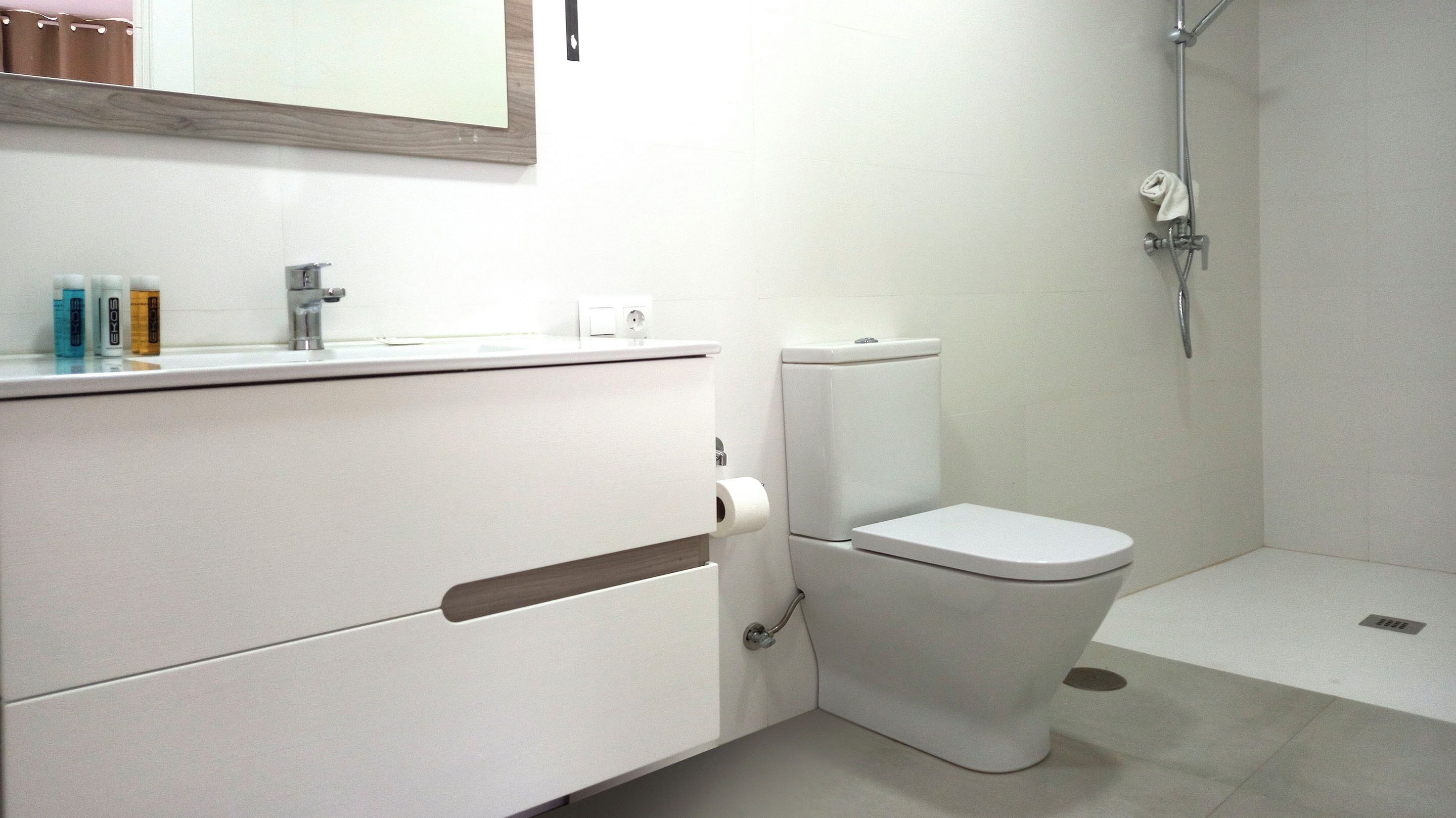Ein modernes Badezimmer mit Toilette, Waschbecken und Dusche.