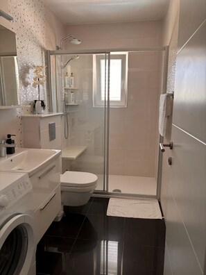 Shower, hair dryer, towels, soap