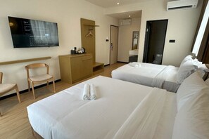 A hotel room with two beds, a desk, a chair, a TV, and a wardrobe. - Hotel Mirda Puncak Alam (Ijok)