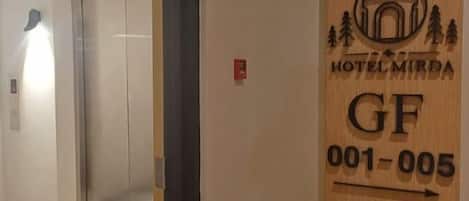 Puerta de habitación de hotel con un logotipo y número de habitación.