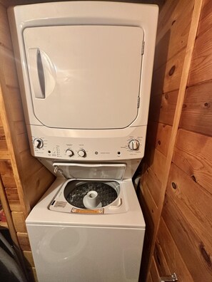 A compact washer and dryer unit with a control panel, a transparent drum, and a front-loading design. - Julies Cabin in Lakeside (Lakeside)