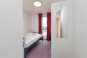 Desk, laptop workspace, bed sheets