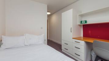 Desk, laptop workspace, bed sheets