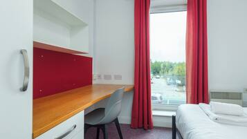 Desk, laptop workspace, bed sheets