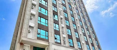 Un edificio alto con numerose finestre e una facciata piatta.