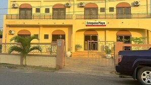 A two-story building with a sign reading "Estepona Playa". - Estepona Playa (Accra)