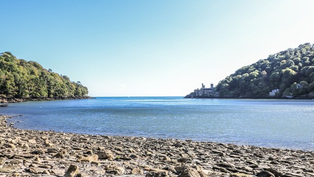 A rocky beach with calm water and hills on either side. - Fastnet at Nonsuch House (Dartmouth)