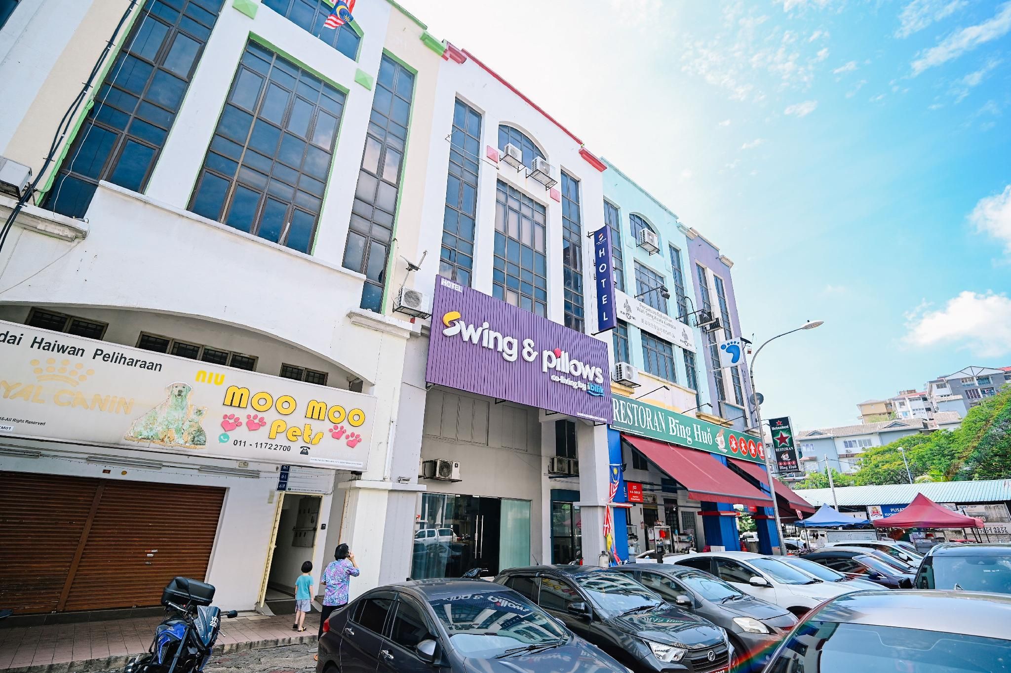 A multi-story building with various businesses including a hotel, a restaurant, and a pet store.