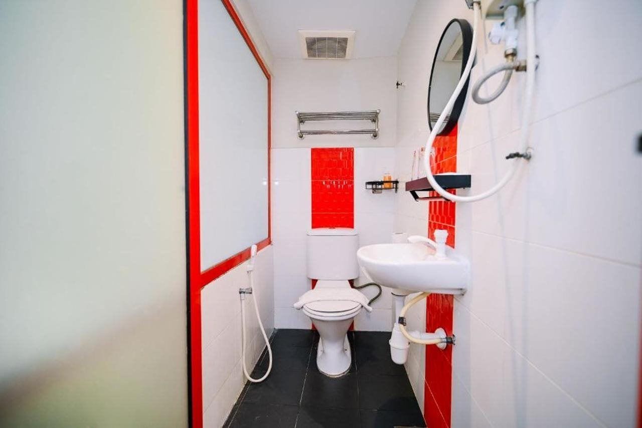 Un baño pequeño y funcional con inodoro, lavamanos y toallero.