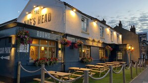 A pub named "The Nag's Head" with outdoor seating and a sign indicating private parking. - The Nags Head (York)