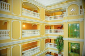 A multi-level interior with balconies, a staircase, and a potted plant. - Siri Heritage Bangkok Hotel (Bangkok)