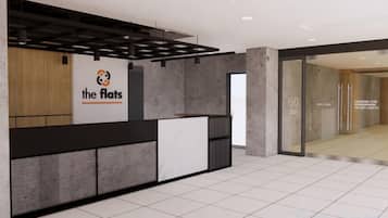 A reception area with a reception desk, a logo, and a glass door leading to another room.