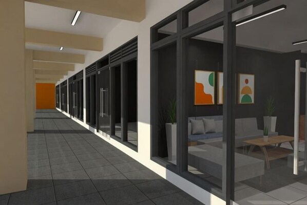 A corridor with glass doors, a reception area with a sofa and table, and artwork on the walls. - The City Flats Circuit Makati (Makati)