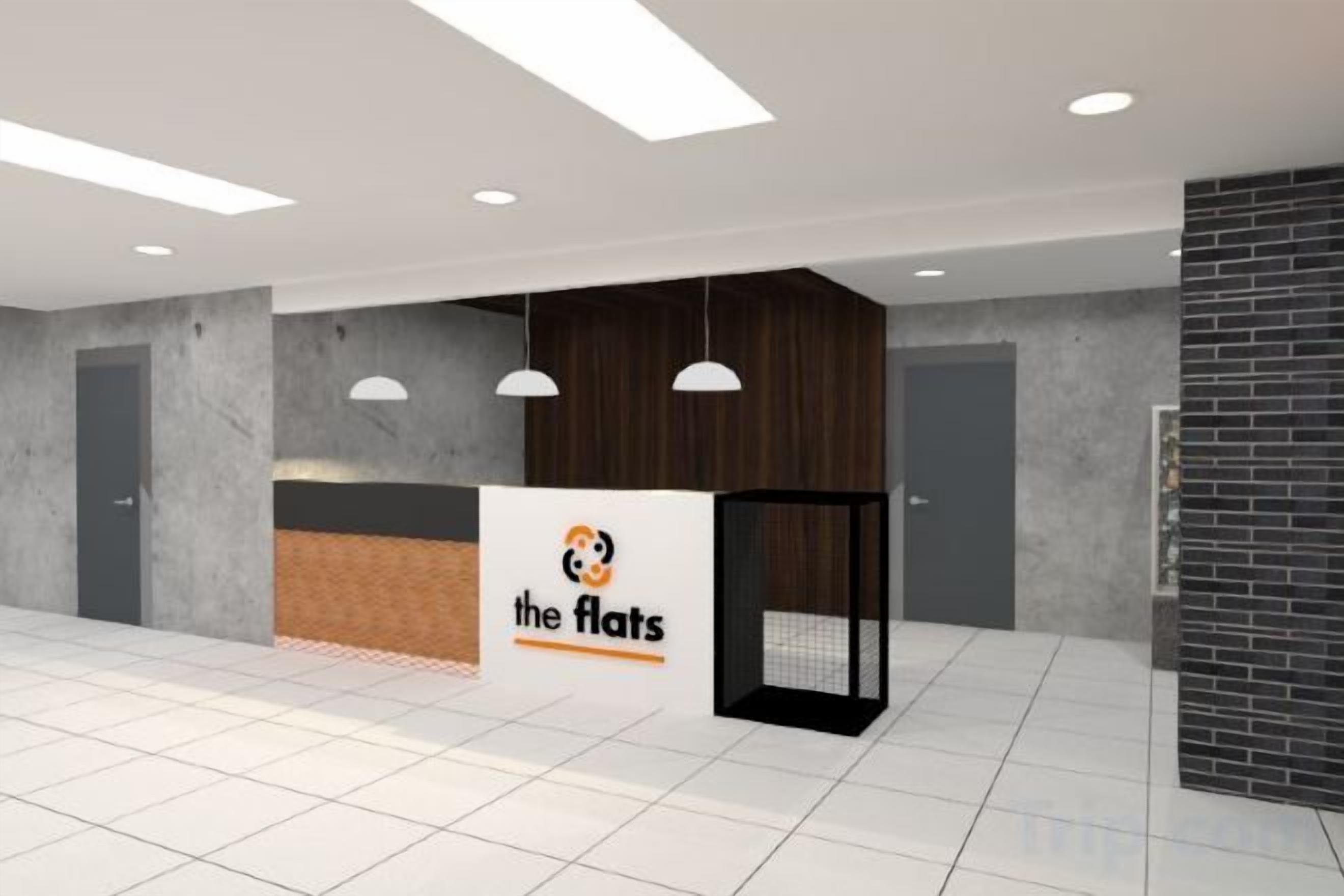 A reception area with a reception desk, pendant lighting, and a tiled floor.