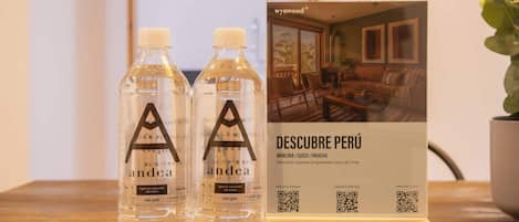 Two bottles of water and a brochure on a table.