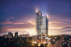 A high-rise building with a modern design, featuring multiple floors and a prominent entrance. - The Alfa Bangsar by City Keys (Kuala Lumpur)