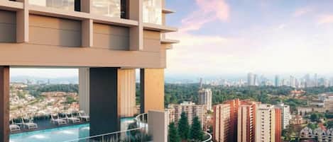 A modern building with a rooftop pool overlooking a cityscape.