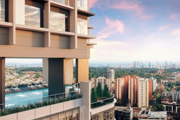 A modern building with a rooftop pool overlooking a cityscape. - The Alfa Bangsar by City Keys (Kuala Lumpur)