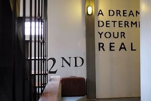 A wall with motivational text and a number '2ND' partially visible. - Sailomyen Cafe and Hostel (Vientiane)