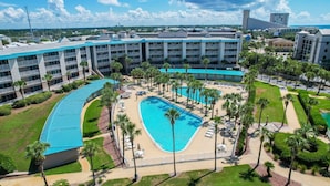 A hotel with multiple floors, a central swimming pool, and surrounding palm trees. - Premier Gulf Views • Private Balcony • Freshly Updated | Amalfi 303A (Miramar Beach)
