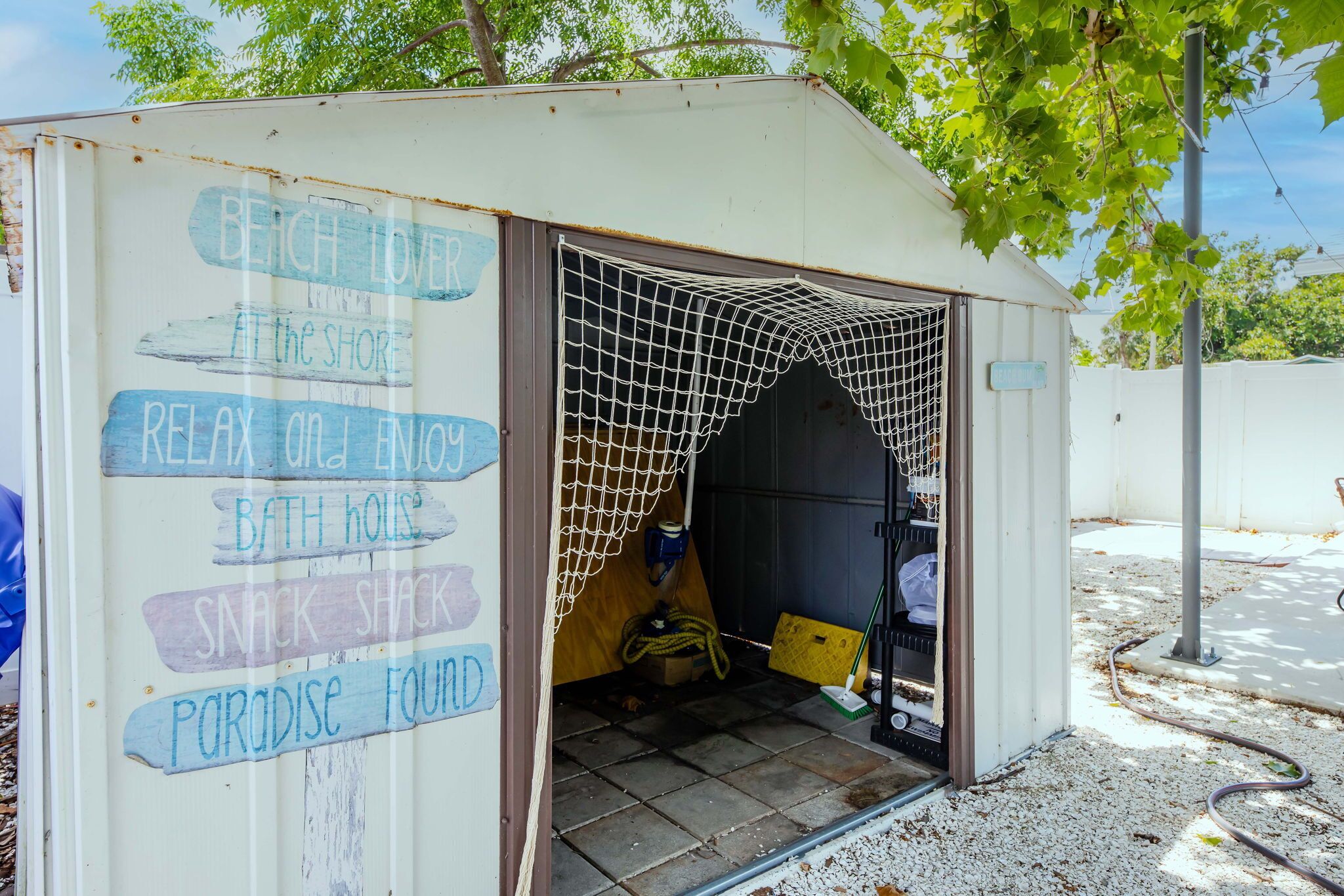 A small, open-sided structure with a netted entrance, labeled with various amenities such as a beach, a snack shack, and a paradise found.