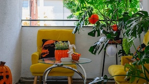 A bright room with a yellow armchair, a glass table, and a potted plant. - Sun-filled Modern Getaway w Spacious Areas 4 (Altadena)