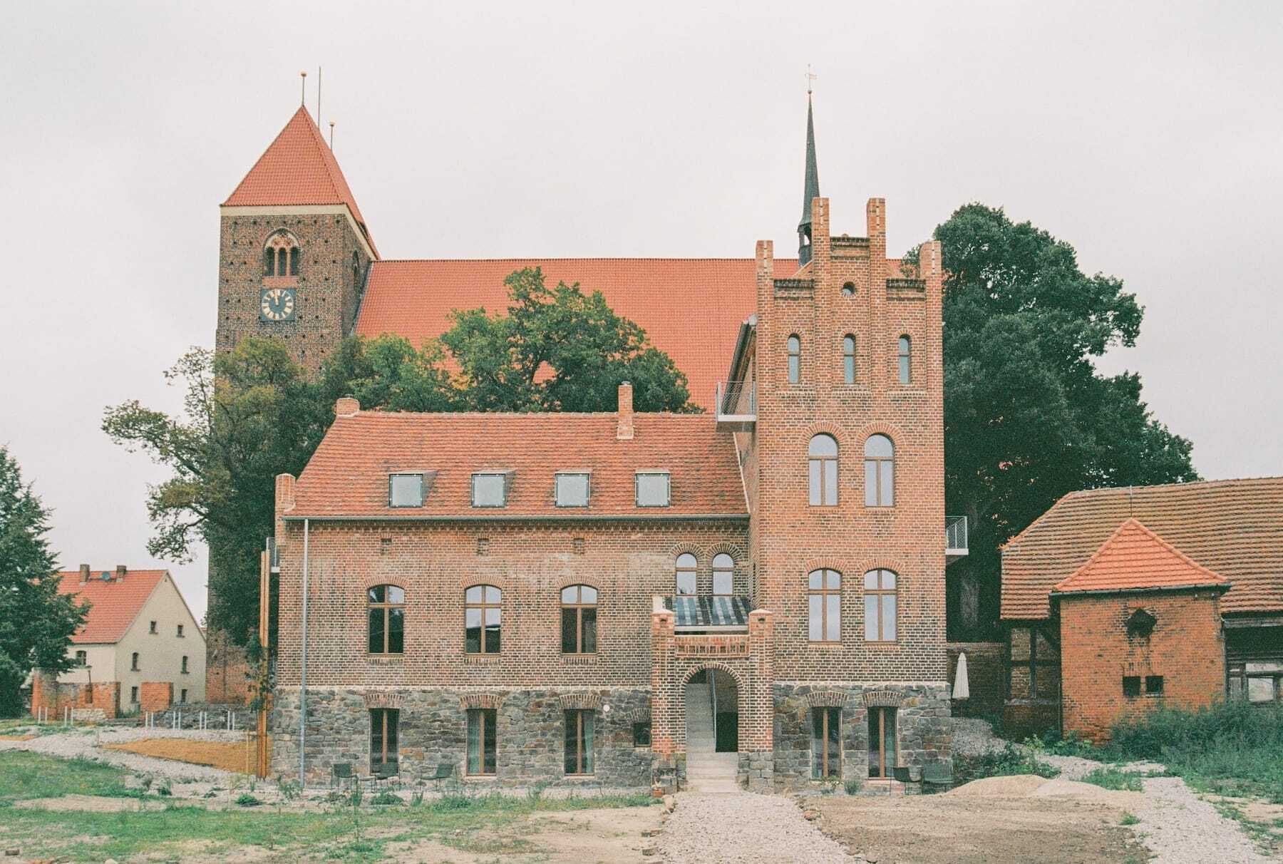 A historic building with a prominent tower and a large arched entrance.