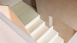 A modern staircase with a minimalist design, featuring clean lines and a neutral color palette. - GARDEN FLOOR EAST: wood-burning stove and terrace to the southeast (Werben)