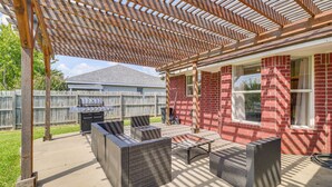 An outdoor patio with wicker furniture, a grill, and a pergola. - Fenced-in Yard: Family Home 4 Mi to Dtwn Killeen! (Killeen)