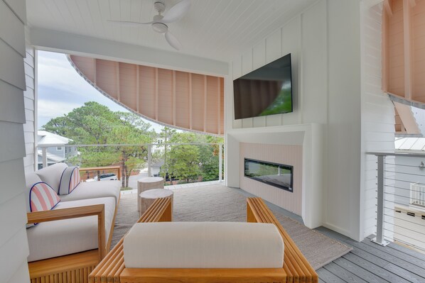 A modern living room with a sofa, wooden coffee table, and a flat-screen TV mounted on the wall. - Stroll to Shore, Modern Santa Rosa Beach Duplex! (Santa Rosa Beach)