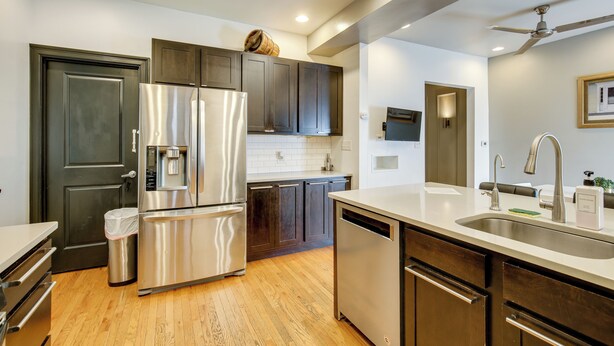 A modern kitchen with stainless steel appliances, wooden cabinets, and a built-in dishwasher. - Walk to Tower Grove Park: St Louis Getaway (St. Louis)
