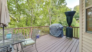 A wooden deck with a table and chairs, a grill, and a covered grill area. - Family Home w/ Deck: 12 Mi to Downtown Nashville! (Nashville)
