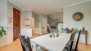 A dining area with a white table, black chairs, and a wall clock. - Family Home w/ Deck: 12 Mi to Downtown Nashville! (Nashville)