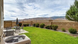 A backyard with a patio, a fan, and a view of mountains. - 6 Mi to Dtwn Reno: Mtn-view Retreat w/ Fireplace! (Reno)