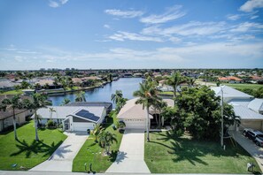 A residential area with houses, a marina, and a clear sky. - Boat Dock & Patio: Cape Coral Home 6 Mi to Beach! (Cape Coral)