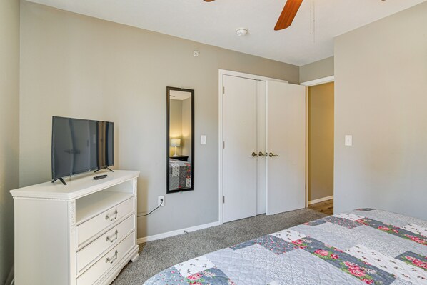 A bedroom with a bed, a dresser, a TV, a wardrobe, and a mirror. - Whimsy on the Hillside!' Family Condo in Branson (Branson)