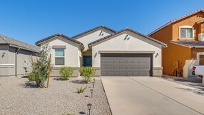 A residential area with houses, a driveway, and a clear sky.