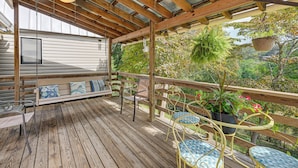 A wooden deck with a bench, chairs, and hanging planters. - Mine for Gems & Chase Waterfalls: Franklin Retreat (Franklin)