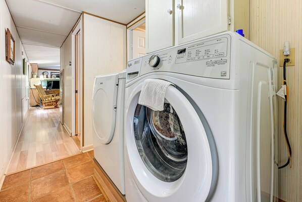 A laundry room with a front-loading washing machine and a dryer. - Mine for Gems & Chase Waterfalls: Franklin Retreat (Franklin)