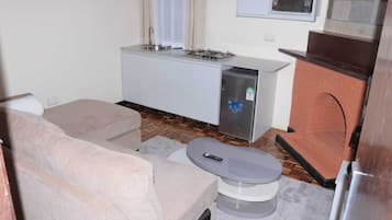 Deluxe Apartment, Garden View | Living area | 32-inch Smart TV with digital channels
