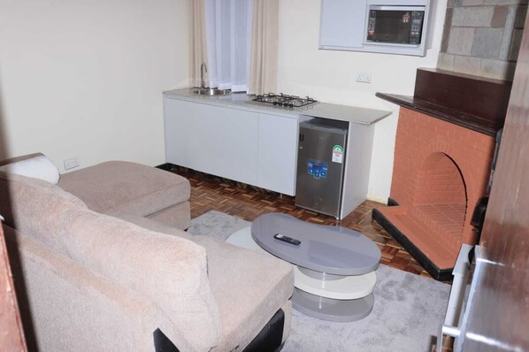 Deluxe Apartment, Garden View | Living area | 32-inch Smart TV with digital channels