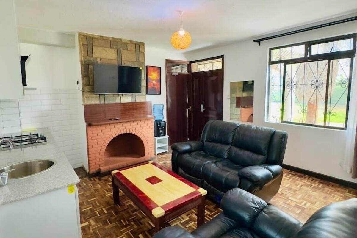 Family Apartment, Garden View | Living area | 32-inch Smart TV with digital channels