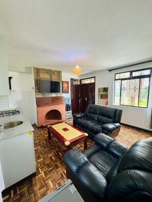 Family Apartment, Garden View | Living area | 32-inch Smart TV with digital channels - Lux Suites Hostpoa Airbnb's Eldoret (Eldoret)