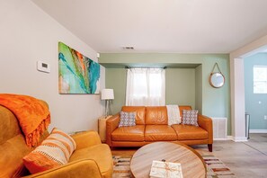 Un salon avec un canapé, un fauteuil et une table basse.