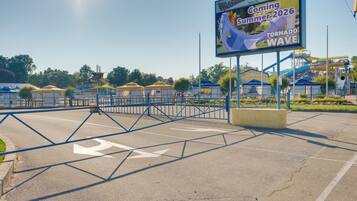 A water park with a sign advertising a new attraction in Summer 2026.