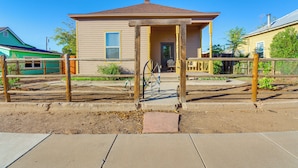 A two-story house with a porch, a front door, and a small front yard. - Walkable Location, Fenced Yard: Wickenburg Home! (Wickenburg)