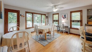 A dining area with a round table, white chairs, and a ceiling fan. - 4 Mi to Dtwn Loveland: Private Retreat w/ Decks (Loveland)