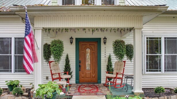 A house with a front porch, two rocking chairs, a flag, and a door. - Walk to UT Southern & Dtwn Pulaski: Historic Home (Pulaski)