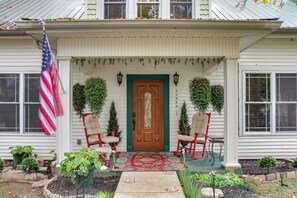 A house with a front porch, two rocking chairs, a flag, and a door. - Walk to UT Southern & Dtwn Pulaski: Historic Home (Pulaski)
