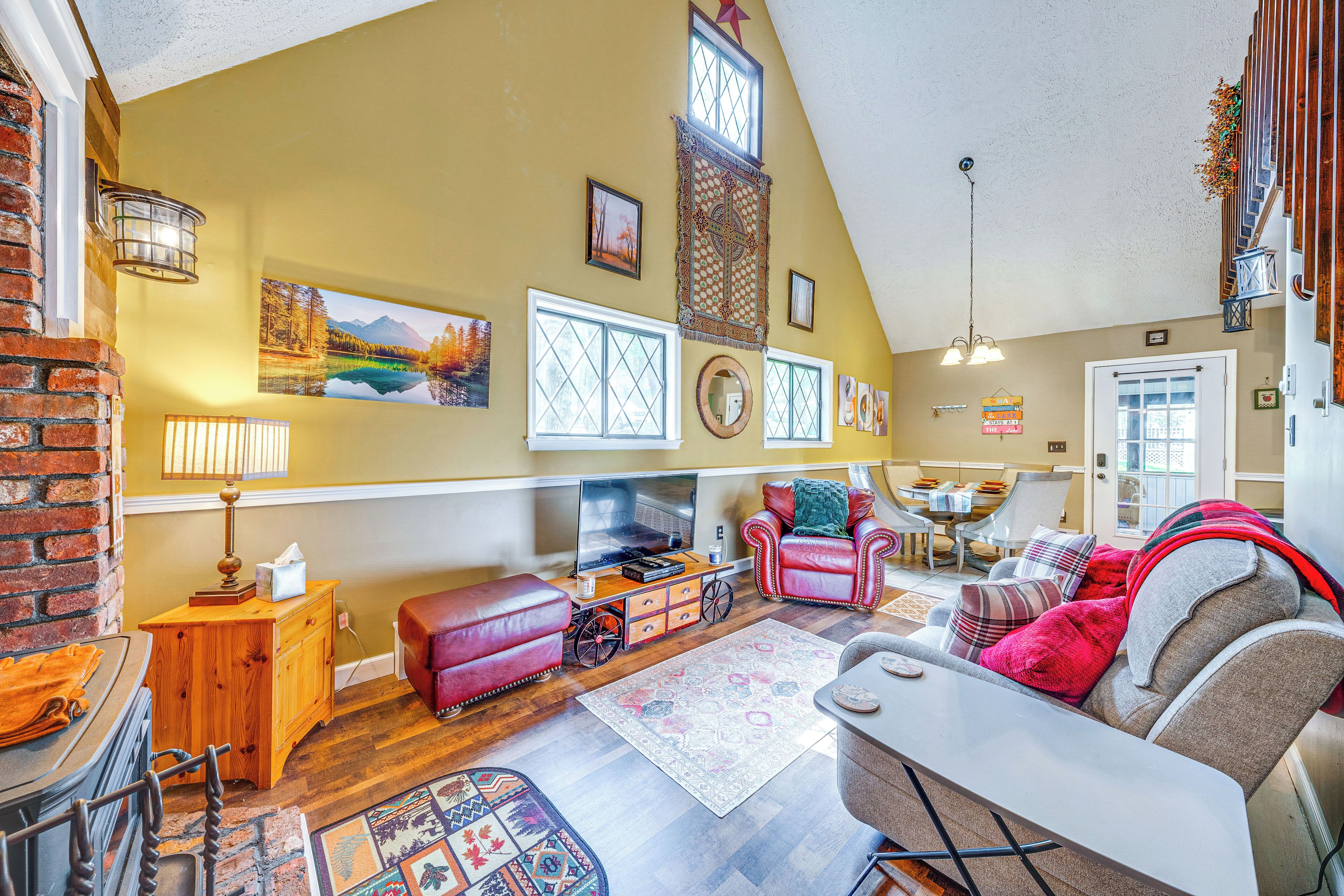 A cozy living room with a fireplace, comfortable seating, and a television.